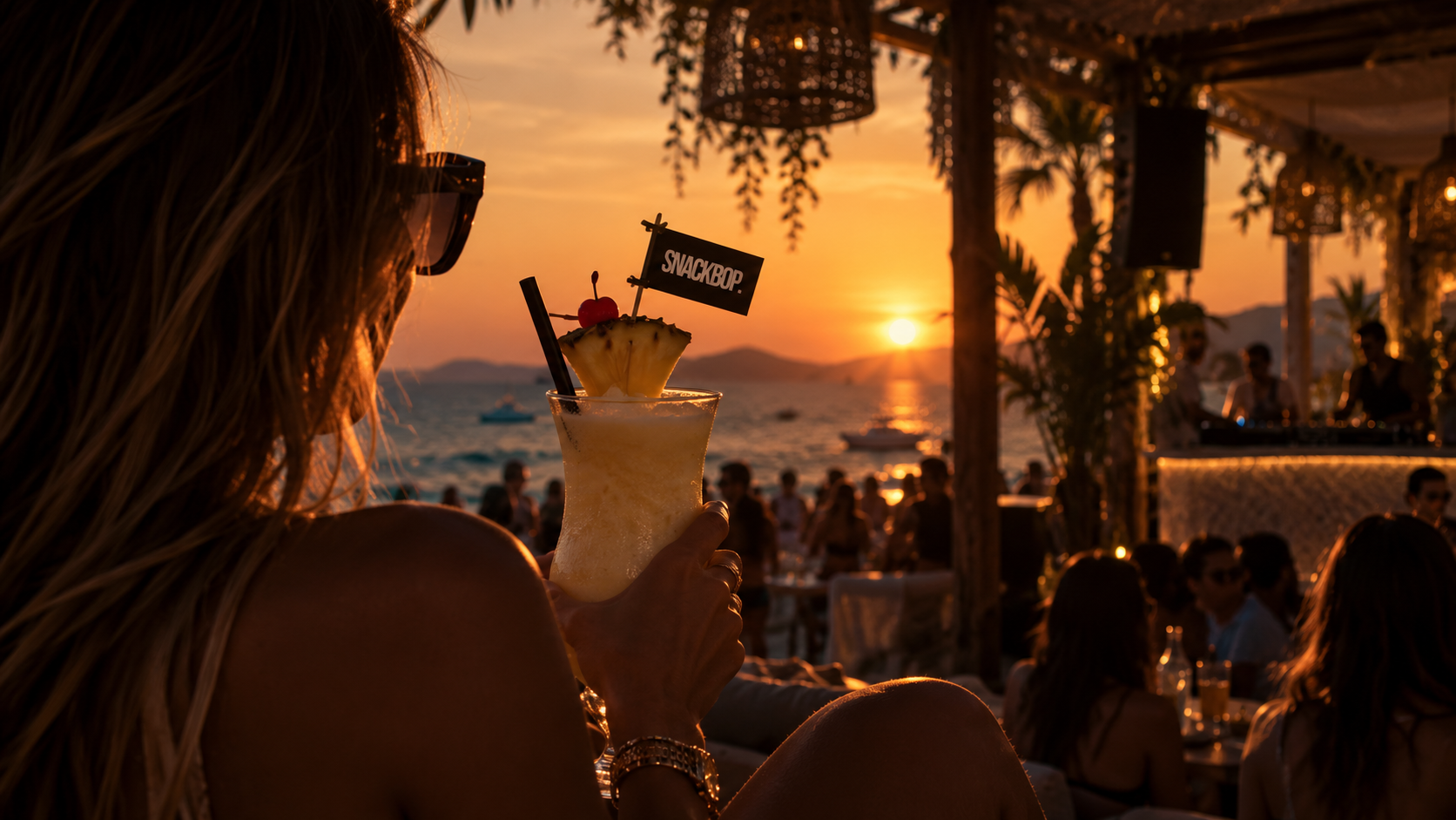 A SNACKBOP drink at a sunset gathering by the sea